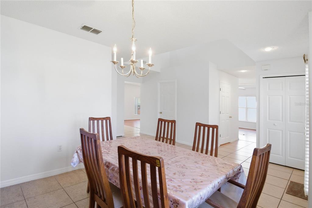 206 Taranto Way Kissimmee, FL 34758 - Photo 7 of 45 a view of a dining room with furniture