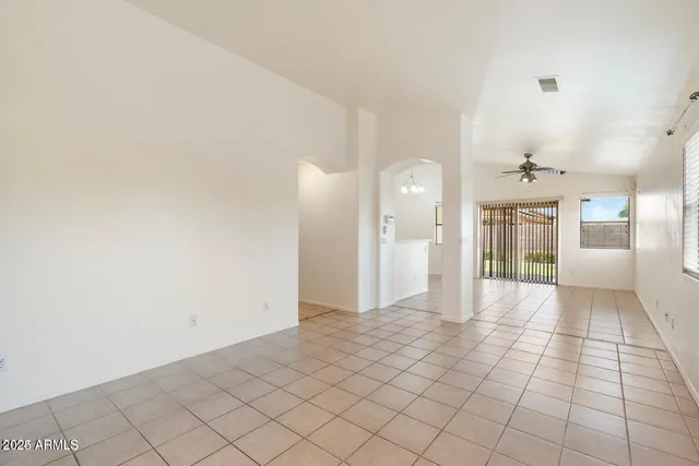 a view of a big room with wooden floor and windows