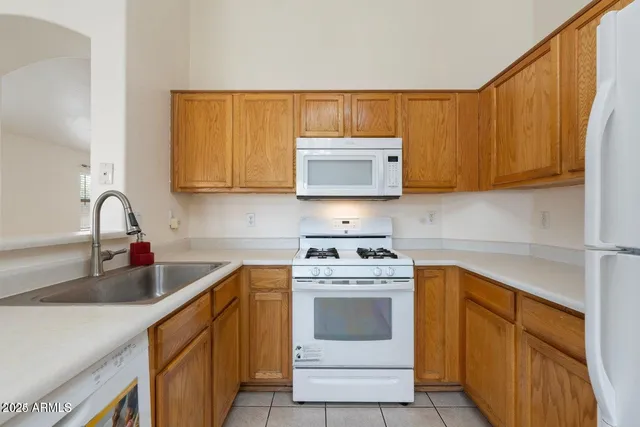 a kitchen with stainless steel appliances granite countertop a sink stove and microwave
