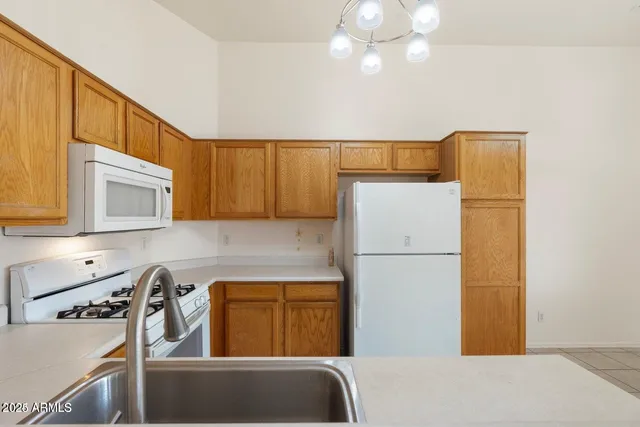 a kitchen with a refrigerator and a sink