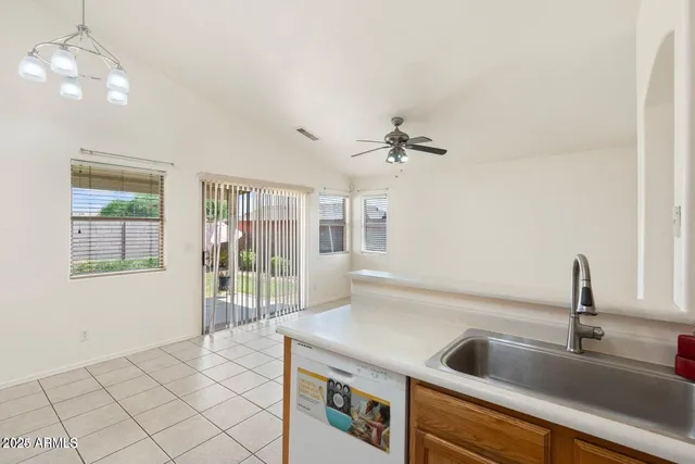 a kitchen with a sink and chandelier