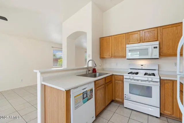 a kitchen with a stove a sink and a microwave