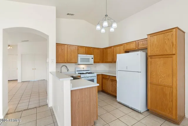 a kitchen with a refrigerator a stove a sink dishwasher and a refrigerator with wooden floor