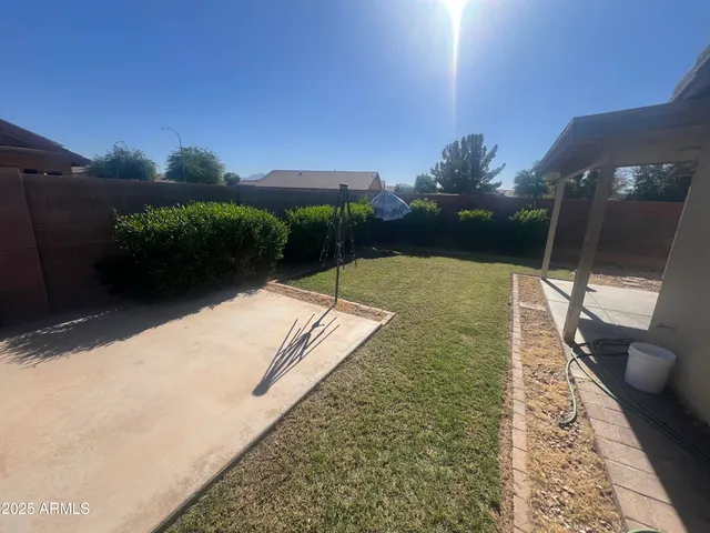 a backyard of a house with table and chairs