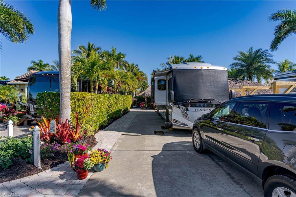 13466 Ladyfish Lane Naples, FL 34114 - Photo 17 of 40 a view of a backyard with couches and potted plants