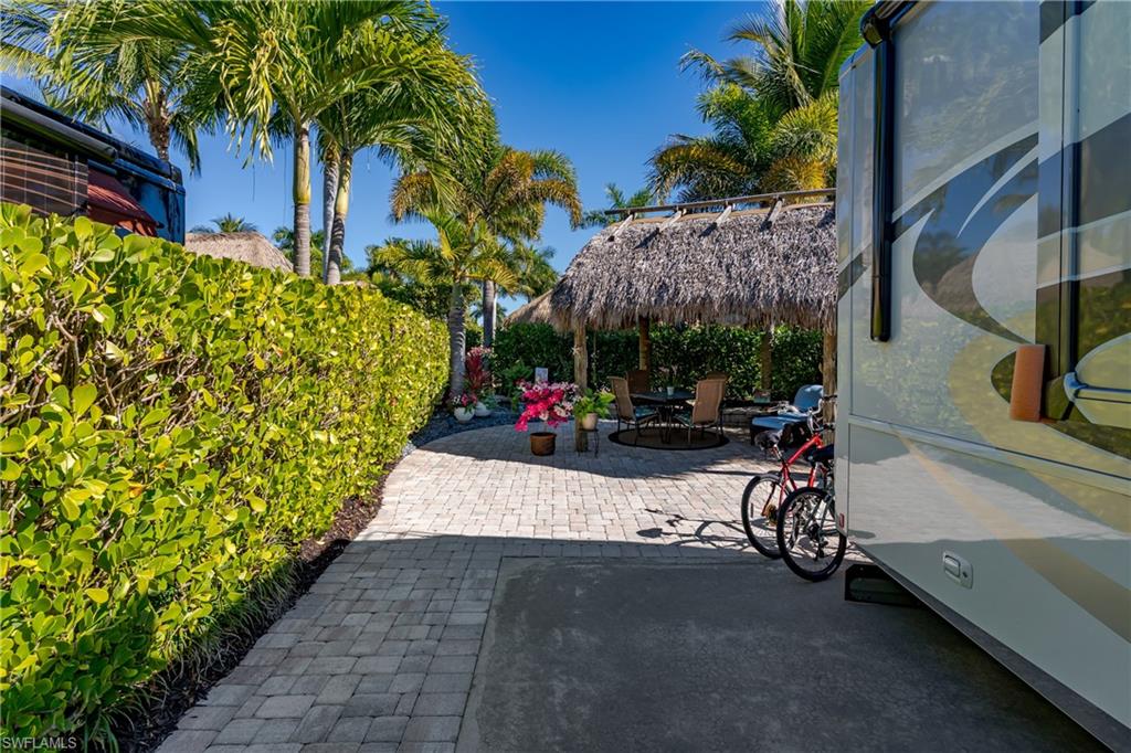 13466 Ladyfish Lane Naples, FL 34114 - Photo 18 of 40 a view of a back yard of the house and cars parked