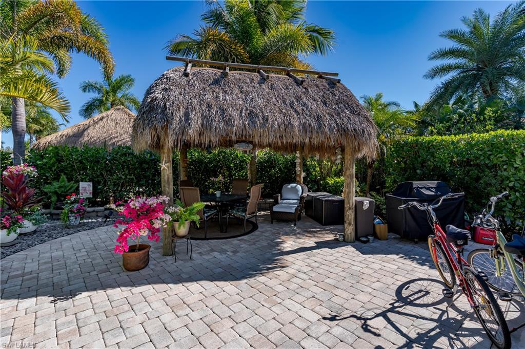 13466 Ladyfish Lane Naples, FL 34114 - Photo 2 of 40 a view of a patio with plants and chairs