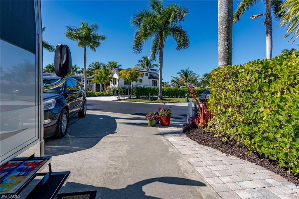13466 Ladyfish Lane Naples, FL 34114 - Photo 21 of 40 a backyard of a house with seating space