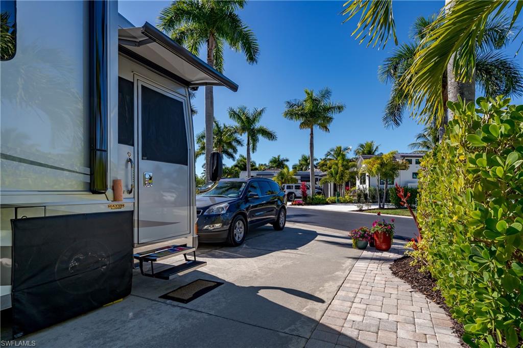 13466 Ladyfish Lane Naples, FL 34114 - Photo 23 of 40 a view of backyard with barbeque grill and potted plants