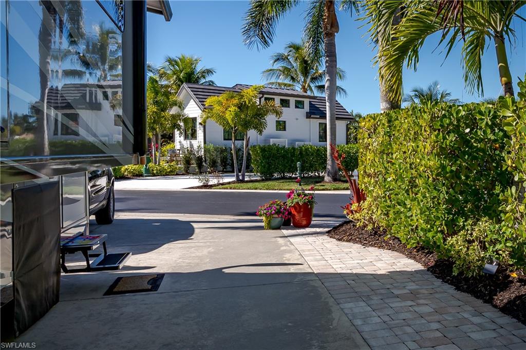 13466 Ladyfish Lane Naples, FL 34114 - Photo 24 of 40 a view of a street with a building in the background