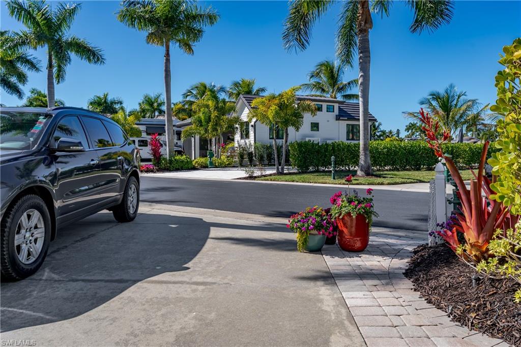 13466 Ladyfish Lane Naples, FL 34114 - Photo 25 of 40 a front view of a house with garden