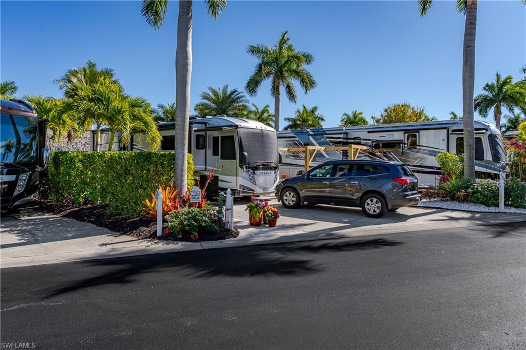 13466 Ladyfish Lane Naples, FL 34114 - Photo 29 of 40 a car parked in front of a house with cars parked