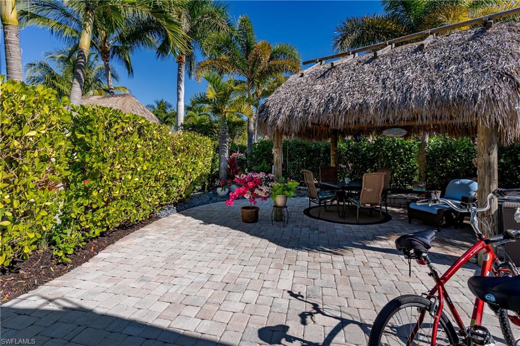 13466 Ladyfish Lane Naples, FL 34114 - Photo 3 of 40 a view of a patio with table and chairs potted plants