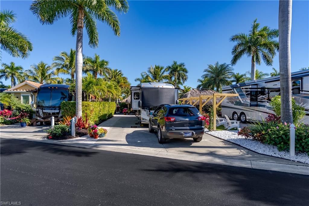 13466 Ladyfish Lane Naples, FL 34114 - Photo 31 of 40 a car parked on the side of a street