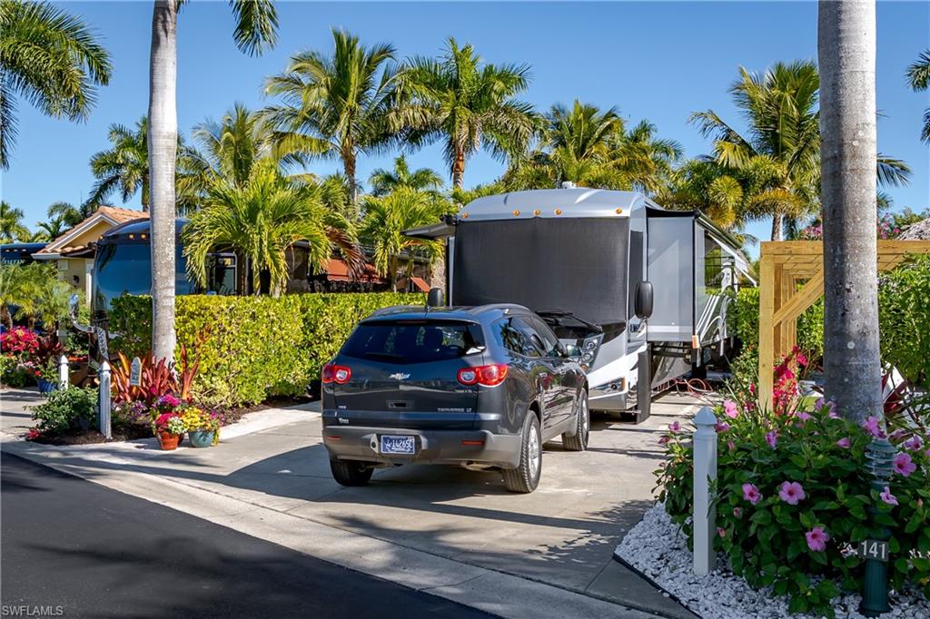 13466 Ladyfish Lane Naples, FL 34114 - Photo 32 of 40 a car parked in front of a house