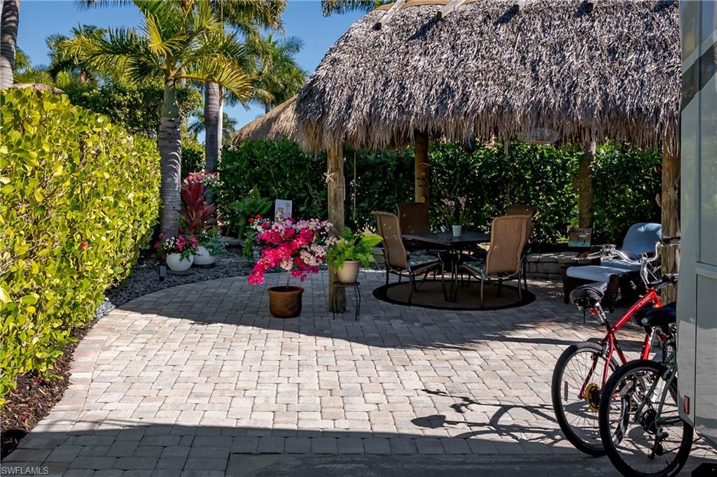13466 Ladyfish Lane Naples, FL 34114 - Photo 4 of 40 a view of a patio with table and chairs potted plants