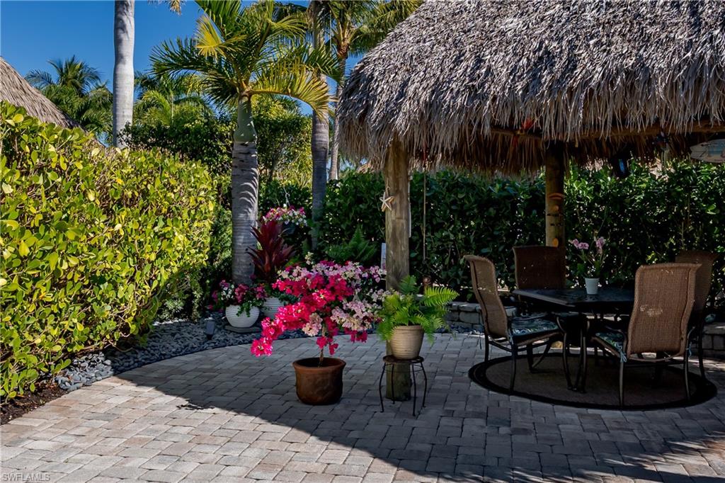 13466 Ladyfish Lane Naples, FL 34114 - Photo 5 of 40 a view of a backyard with plants and patio