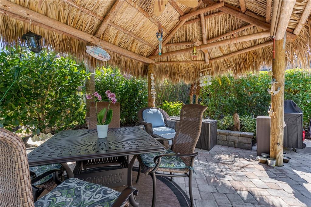 13466 Ladyfish Lane Naples, FL 34114 - Photo 7 of 40 a view of a table and chairs in patio