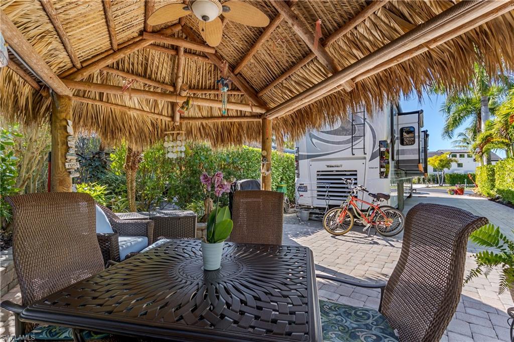 13466 Ladyfish Lane Naples, FL 34114 - Photo 8 of 40 a view of a patio with couches table and chairs and potted plants