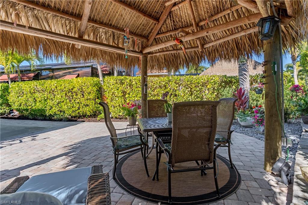 13466 Ladyfish Lane Naples, FL 34114 - Photo 9 of 40 a view of a chairs and table in the patio