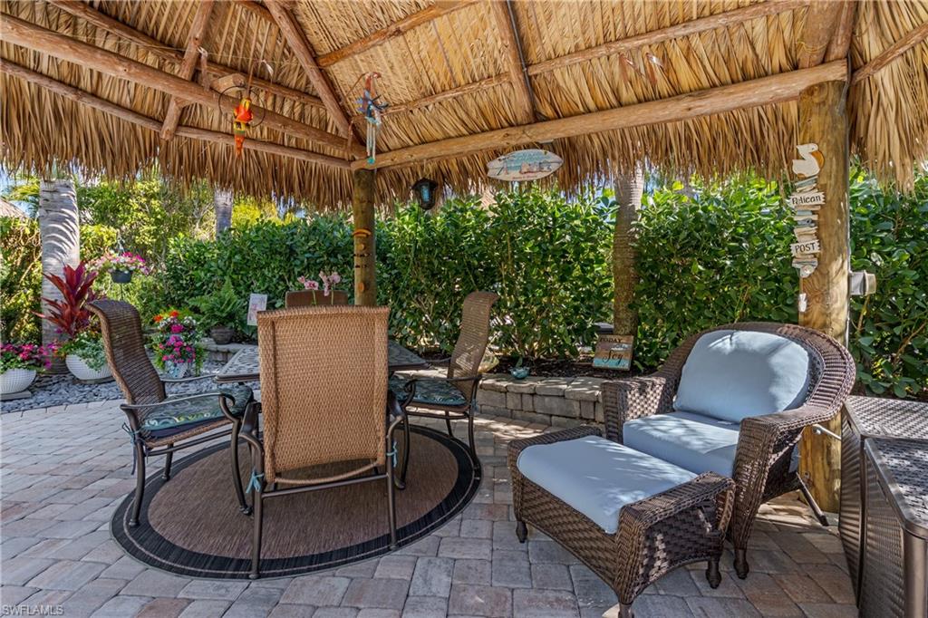 13466 Ladyfish Lane Naples, FL 34114 - Photo 10 of 40 a backyard of a house with table and chairs