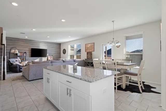 a kitchen with stainless steel appliances granite countertop a sink and a refrigerator