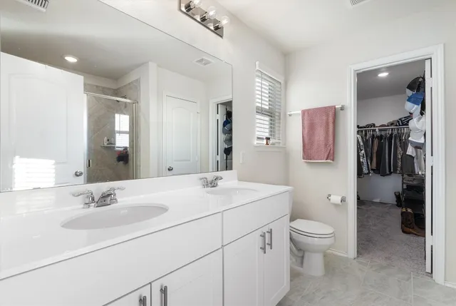 a bathroom with a toilet sink and a mirror