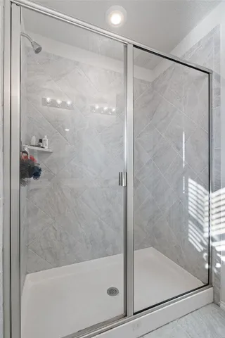 a bathroom with a glass shower door