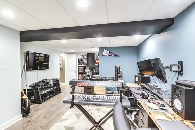 a living room with furniture a flat screen tv and a table