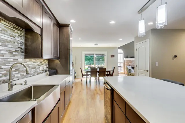 a kitchen with counter top space a sink cabinets and appliances