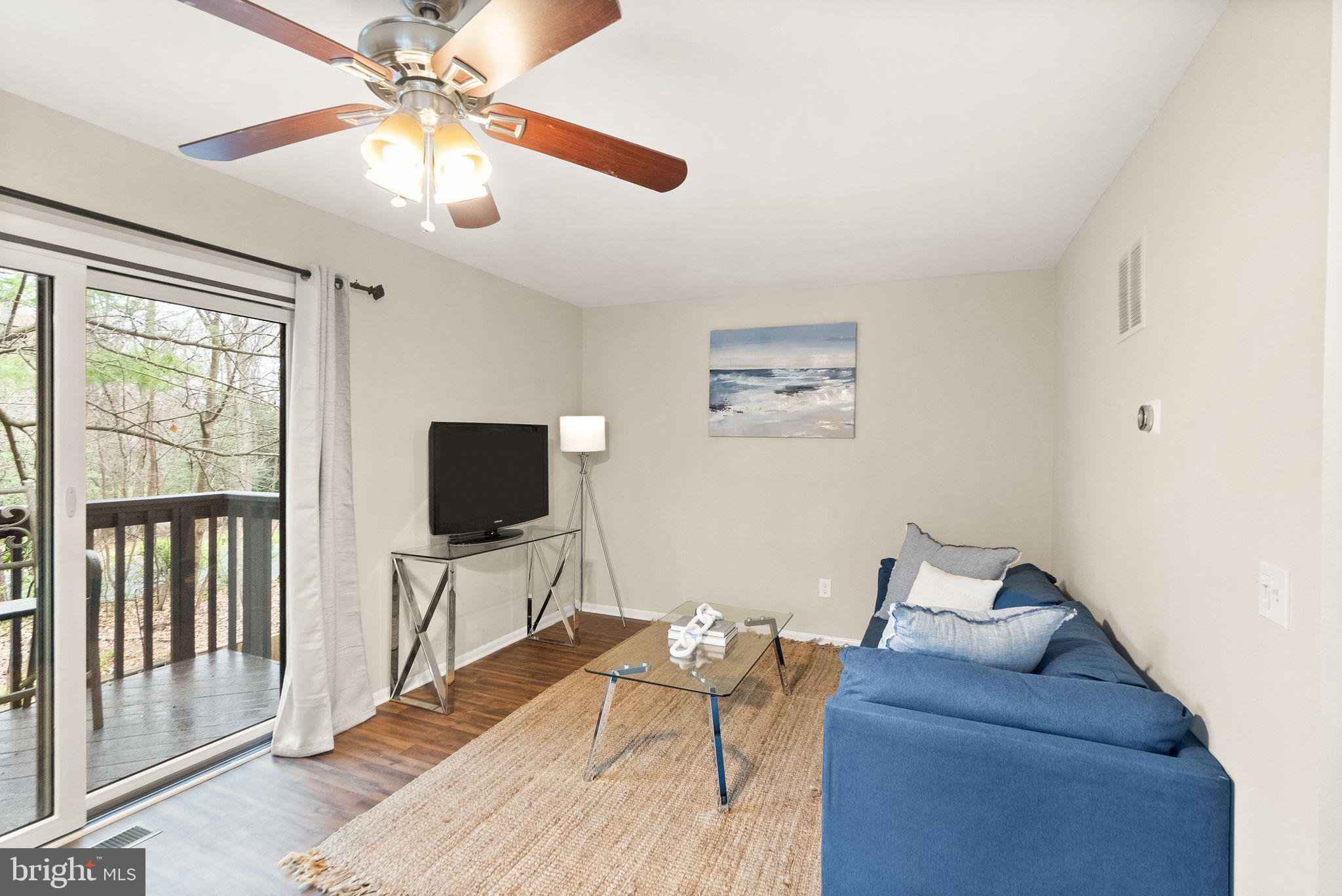 11801 Coopers Court Reston, VA 20191 - Photo 11 of 66 a living room with furniture and a flat screen tv