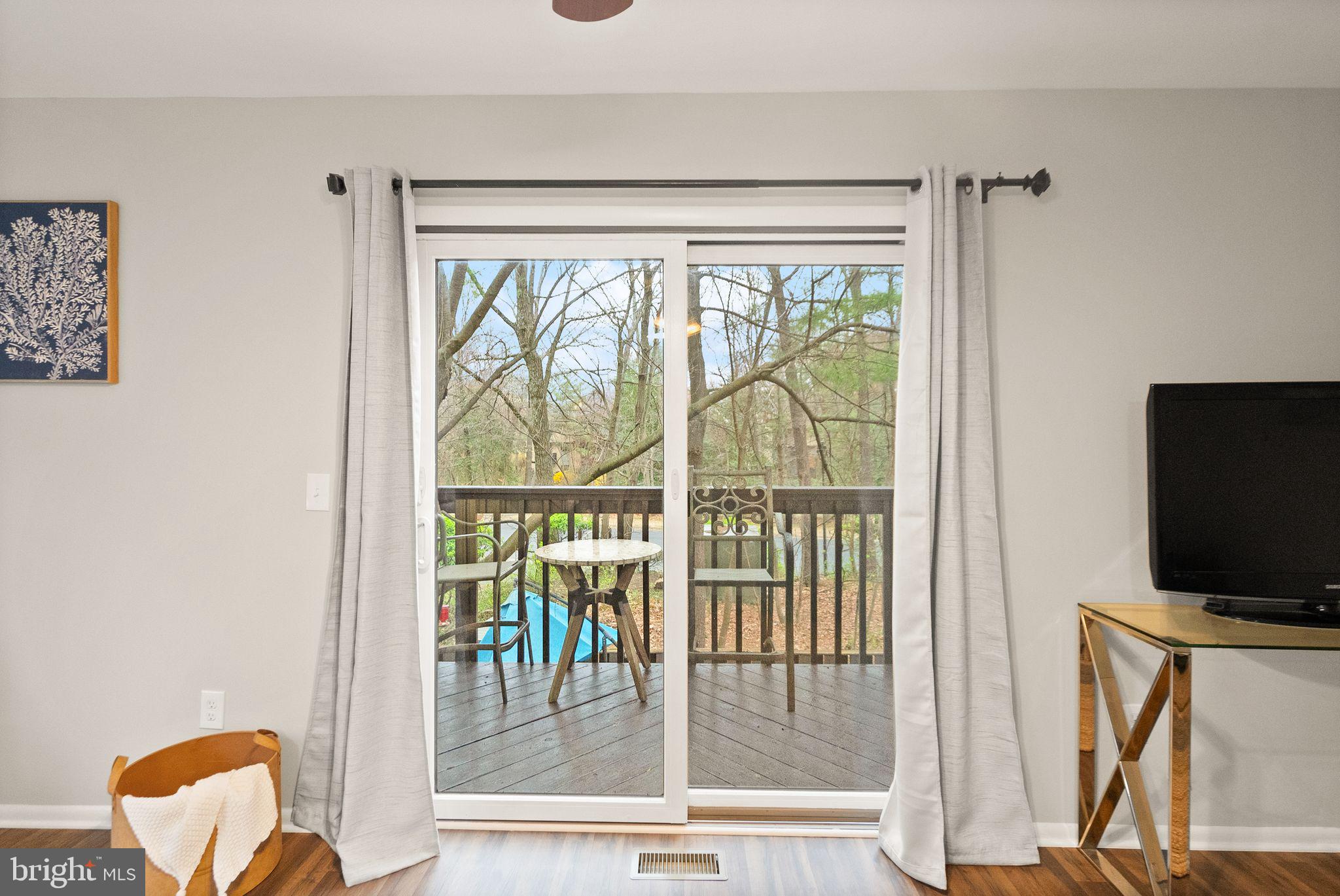 11801 Coopers Court Reston, VA 20191 - Photo 12 of 66 a view of a livingroom with wooden floor and a flat screen tv