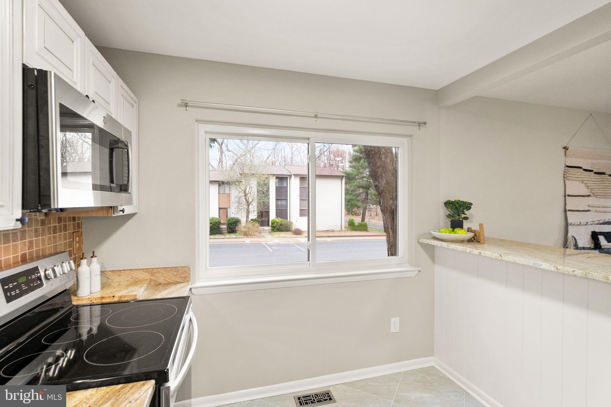 11801 Coopers Court Reston, VA 20191 - Photo 19 of 66 a kitchen with a stove a sink a counter top space and cabinets