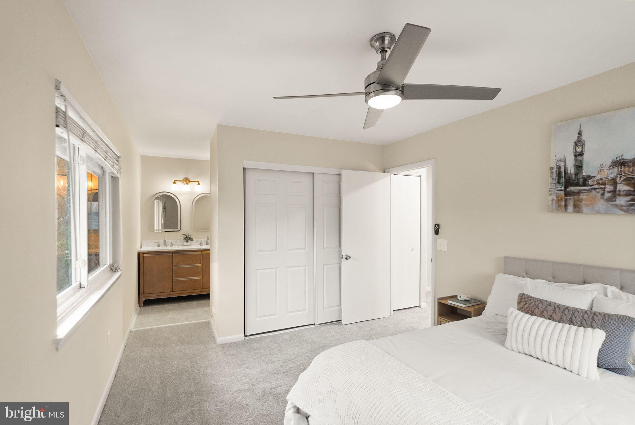 11801 Coopers Court Reston, VA 20191 - Photo 30 of 66 a bedroom with a large bed and a chandelier