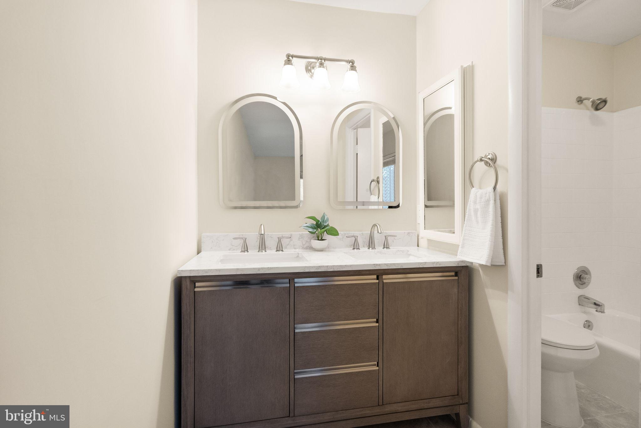 11801 Coopers Court Reston, VA 20191 - Photo 32 of 66 a bathroom with 2 sink and a mirror