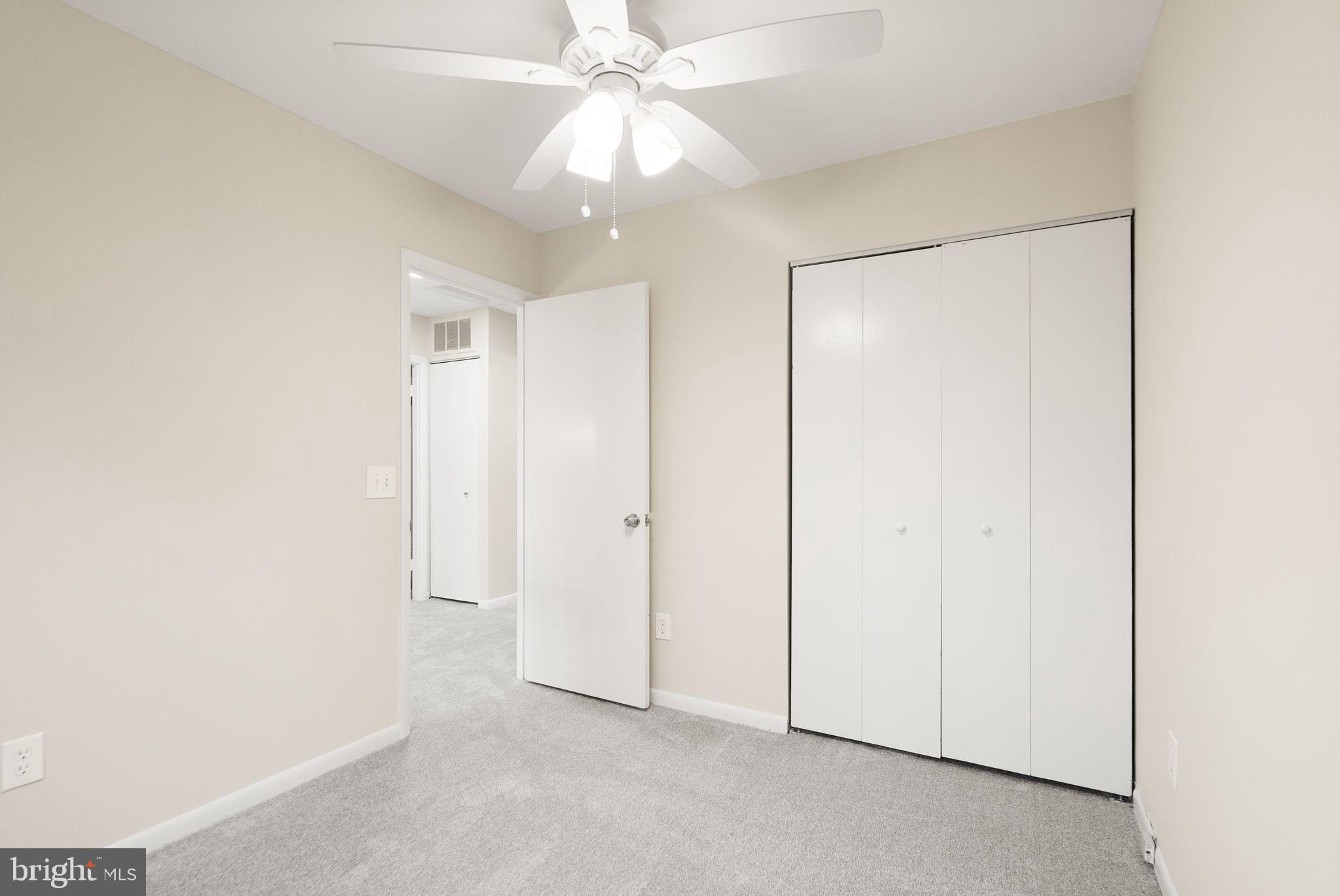 11801 Coopers Court Reston, VA 20191 - Photo 38 of 66 an empty room with a ceiling fan and a window