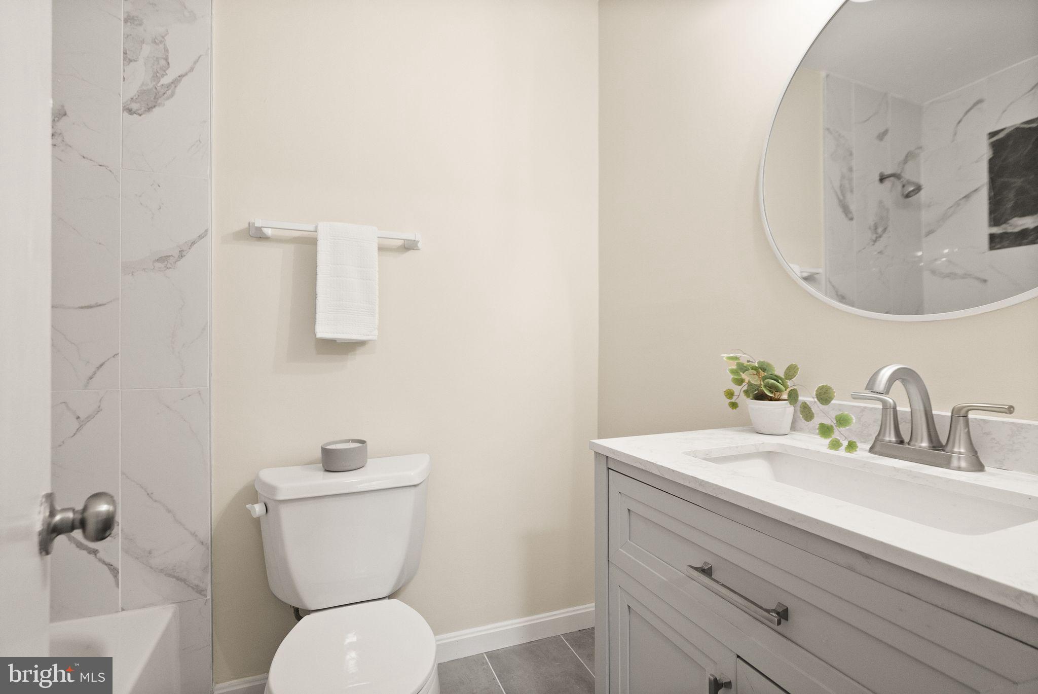 11801 Coopers Court Reston, VA 20191 - Photo 39 of 66 a bathroom with a toilet sink and mirror