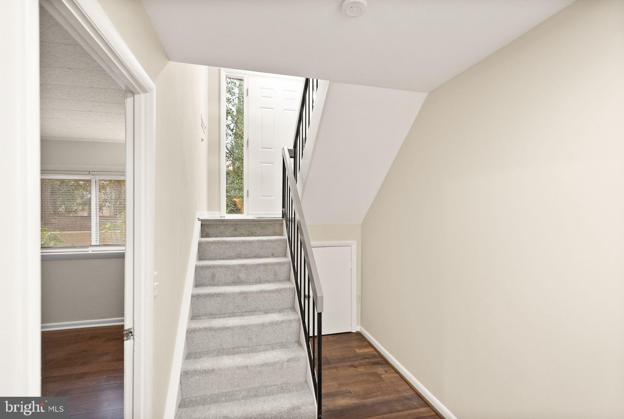 11801 Coopers Court Reston, VA 20191 - Photo 42 of 66 a view of staircase with wooden floor and windows