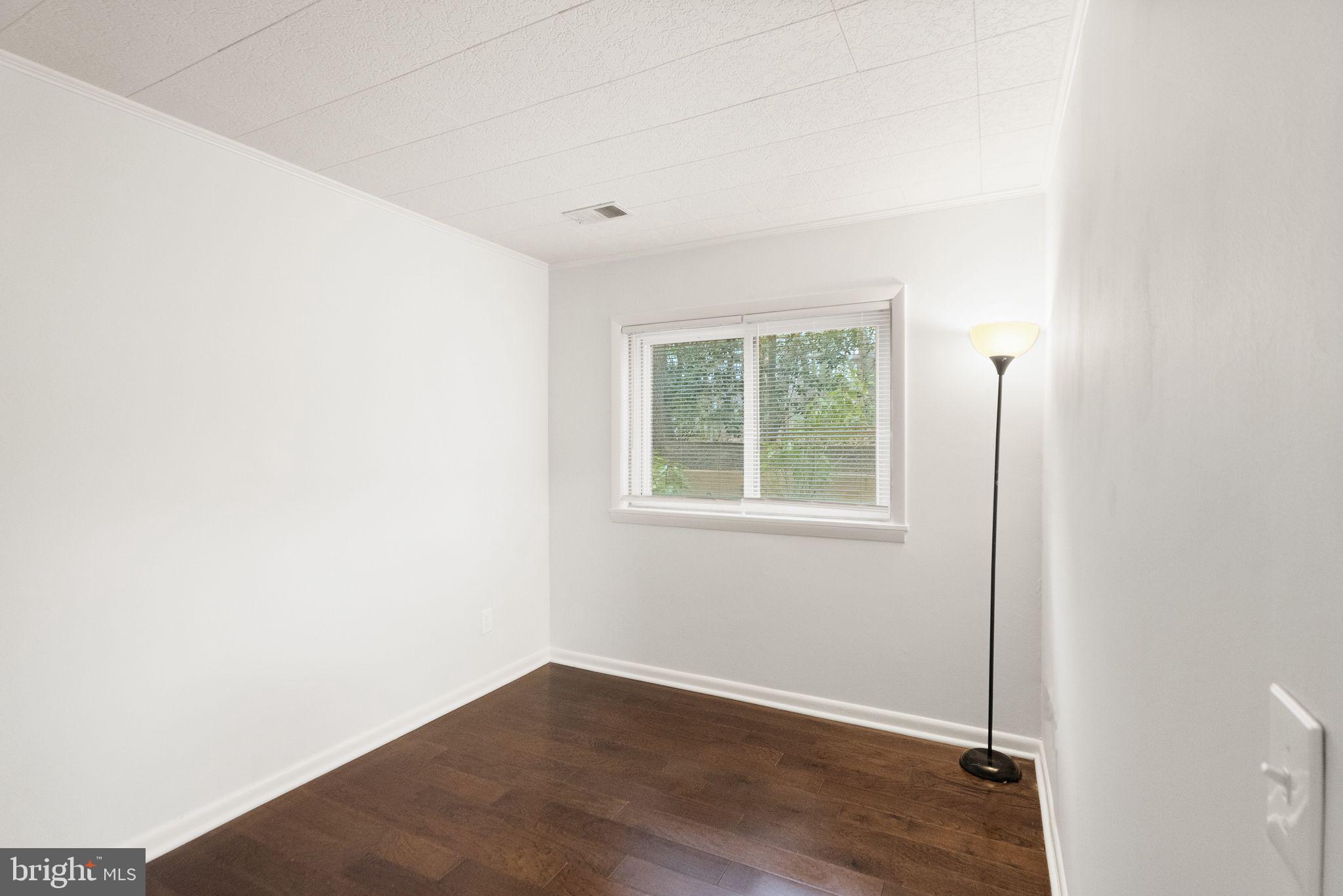 11801 Coopers Court Reston, VA 20191 - Photo 47 of 66 an empty room with wooden floor and windows