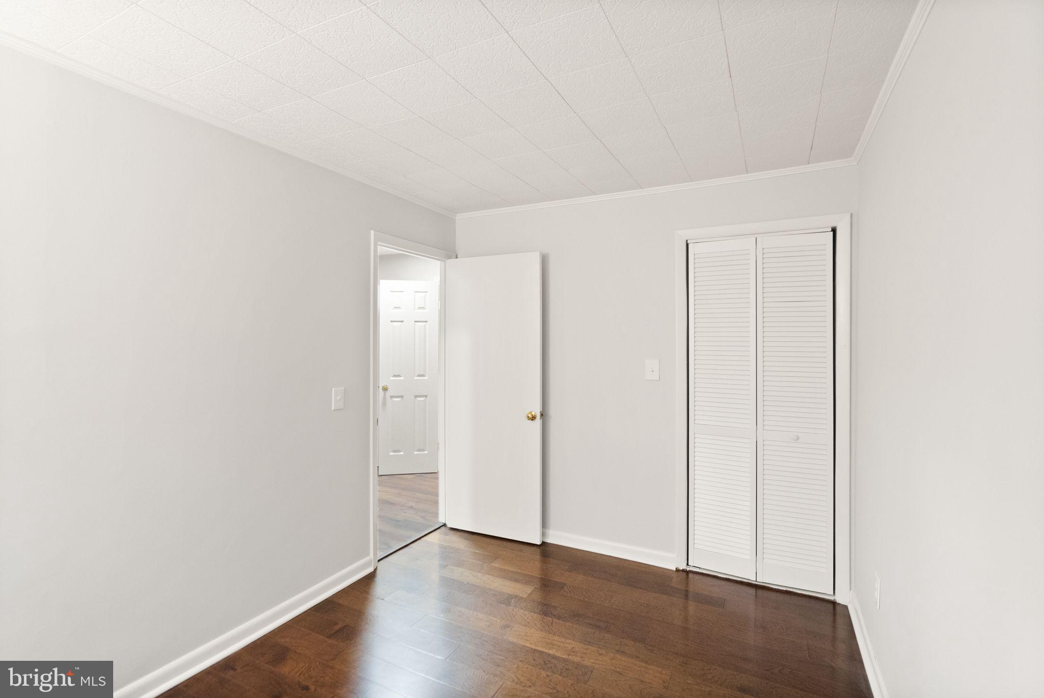 11801 Coopers Court Reston, VA 20191 - Photo 48 of 66 a view of an empty room with wooden floor