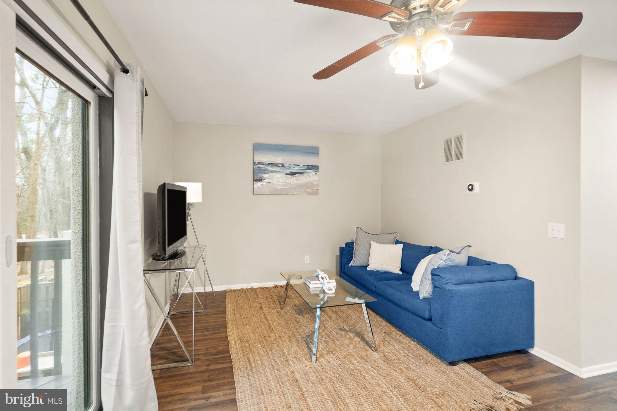 11801 Coopers Court Reston, VA 20191 - Photo 10 of 66 a living room with furniture and a flat screen tv