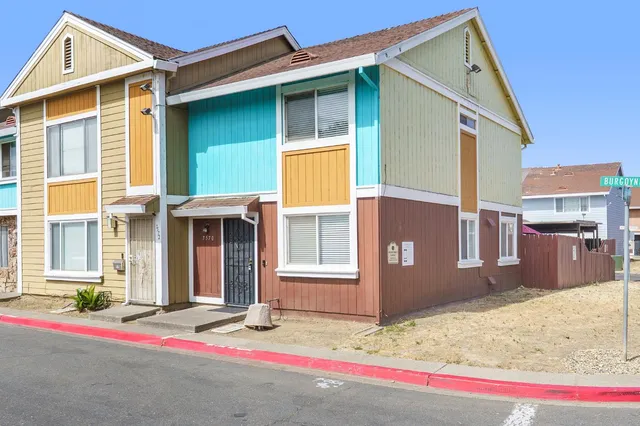a front view of a house with a road
