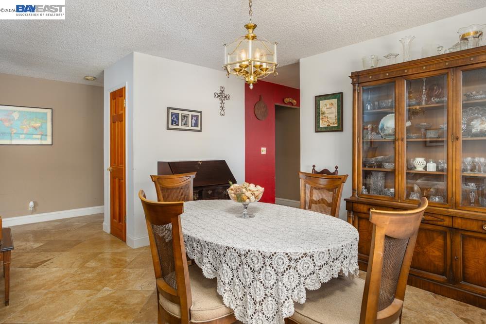 4591 Edwards Lane Castro Valley, CA 94546 - Photo 10 of 44 a dining room with furniture a chandelier and window