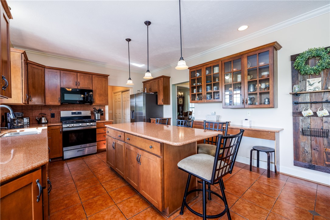4128 River Road York, NY 14533 - Photo 22 of 50 COOK'S KITCHEN WITH BEAUTIFUL CABINETRY & ISLAND