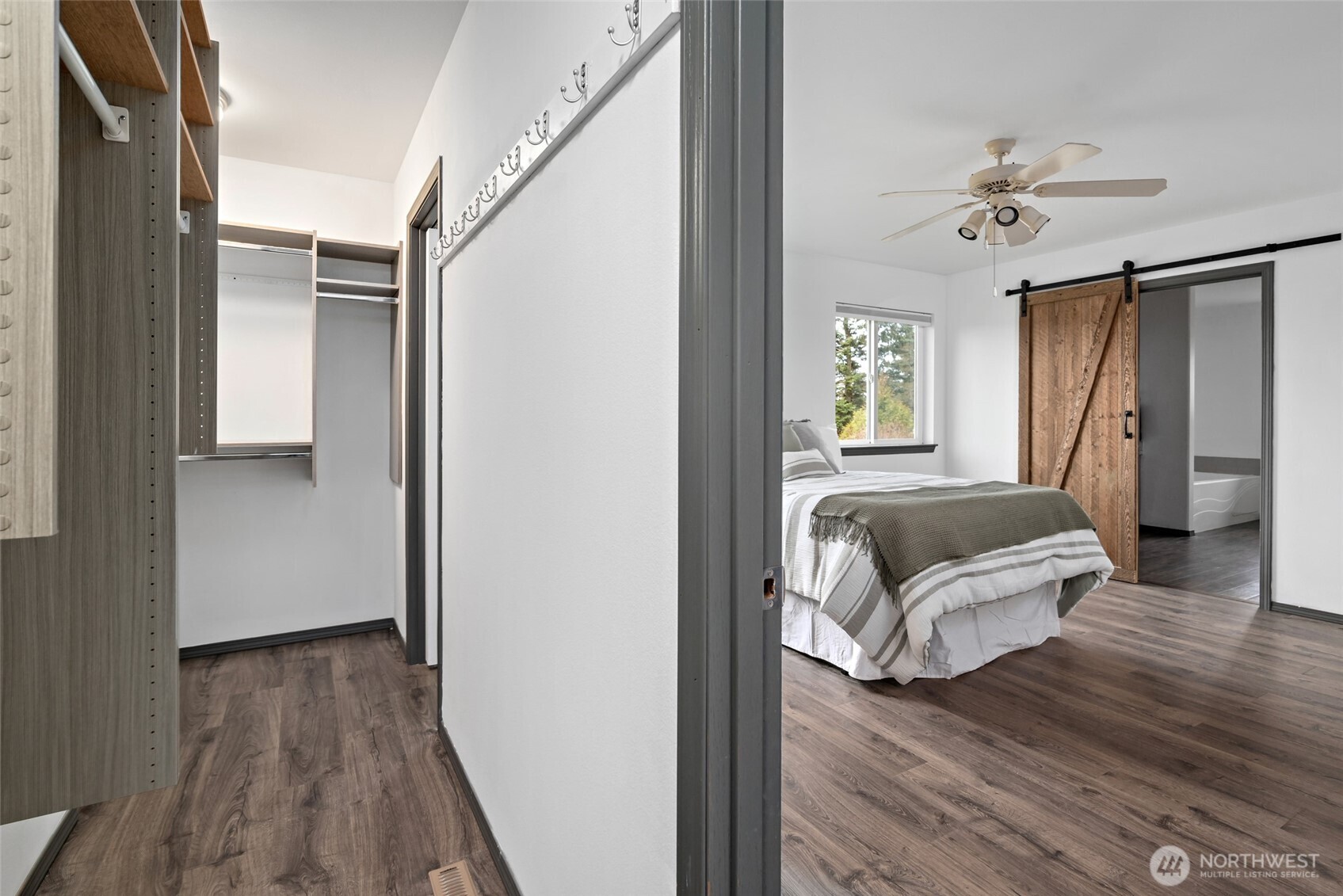 2060 Southwest 16th Avenue Oak Harbor, WA 98277 - Photo 16 of 40 a bedroom with wooden floor and a chandelier