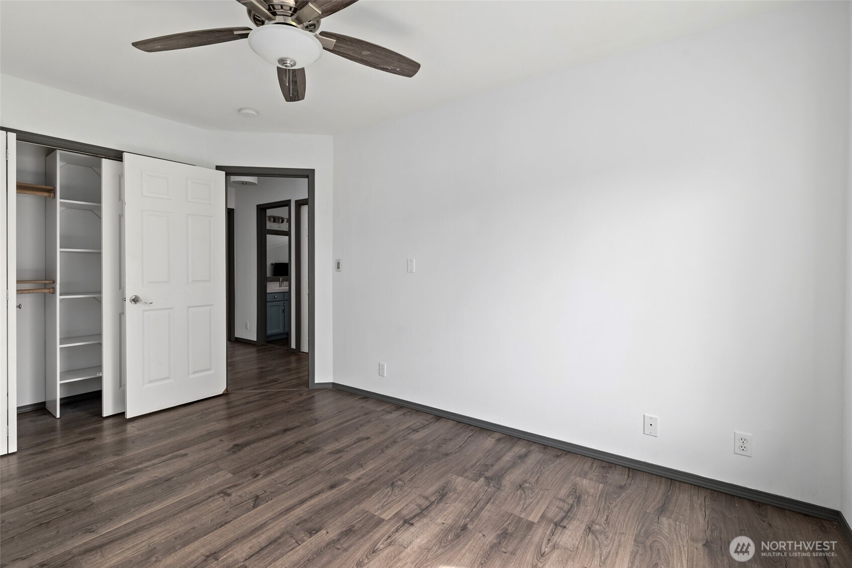 2060 Southwest 16th Avenue Oak Harbor, WA 98277 - Photo 21 of 40 an empty room with wooden floor a ceiling fan and a window