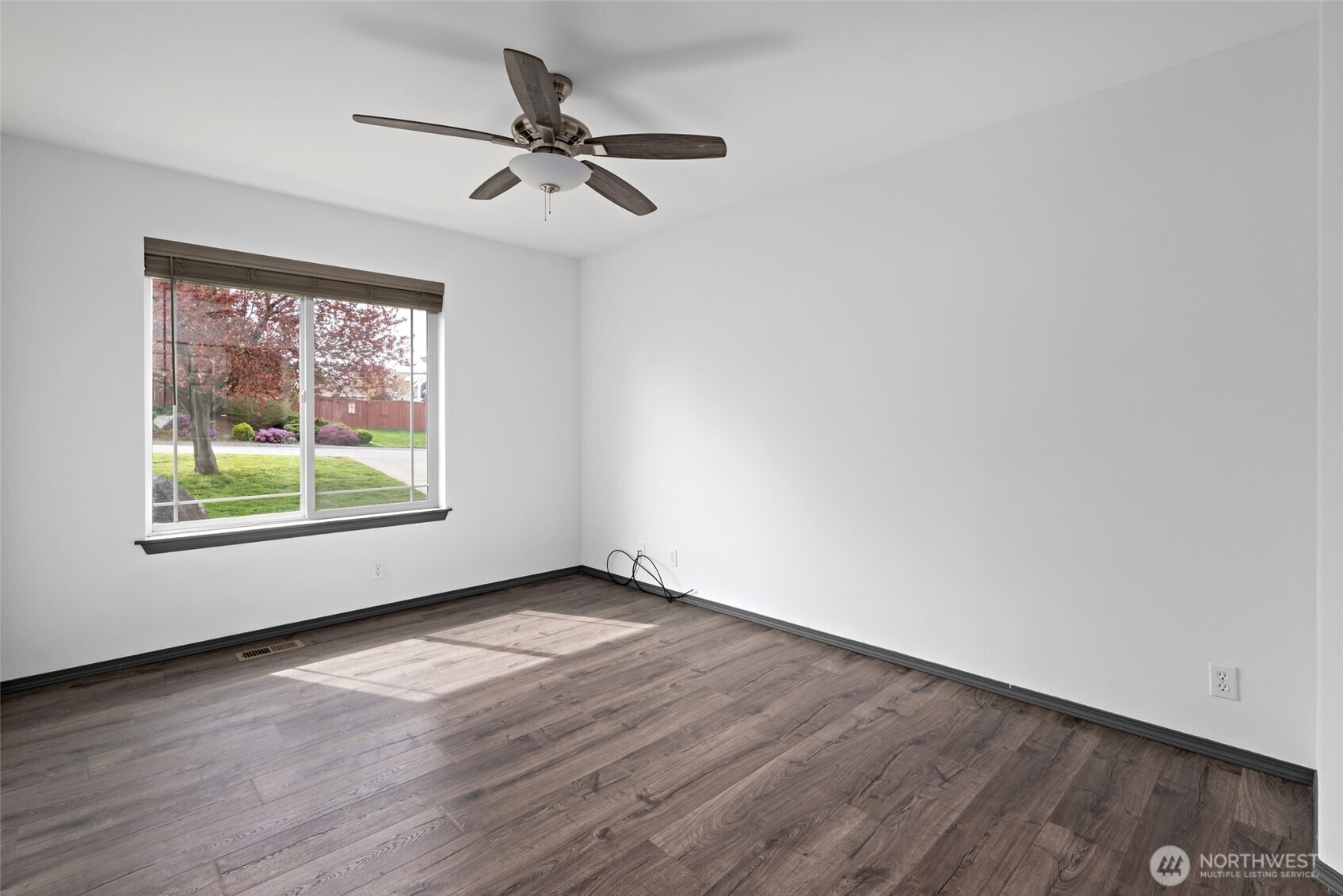 2060 Southwest 16th Avenue Oak Harbor, WA 98277 - Photo 22 of 40 an empty room with wooden floor fan and windows