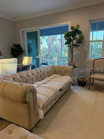 a bedroom with a bed couch and window