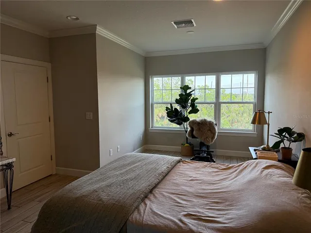 a bedroom with a bed and a chandelier