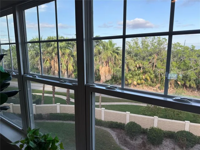 a living room filled with furniture and a floor to ceiling window
